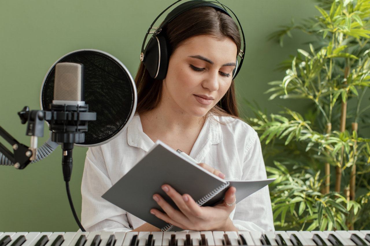 female-musician-playing-piano-keyboard-writing-songs-while-recording.jpg